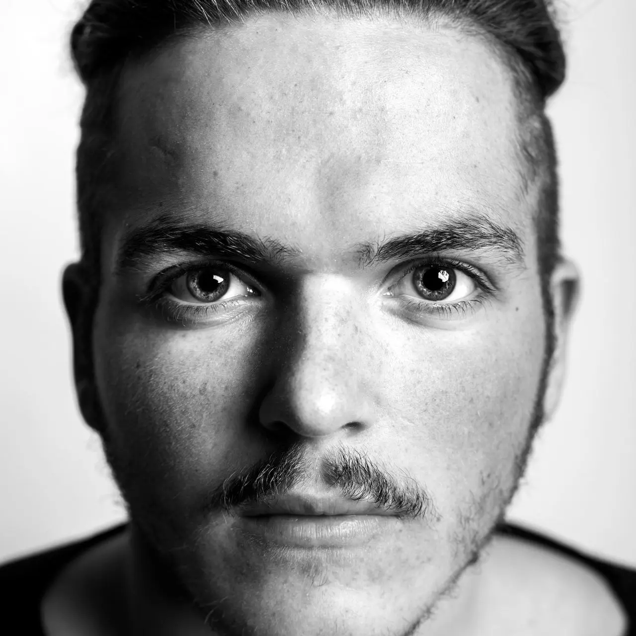 grayscale photography of man in scoop-neck top