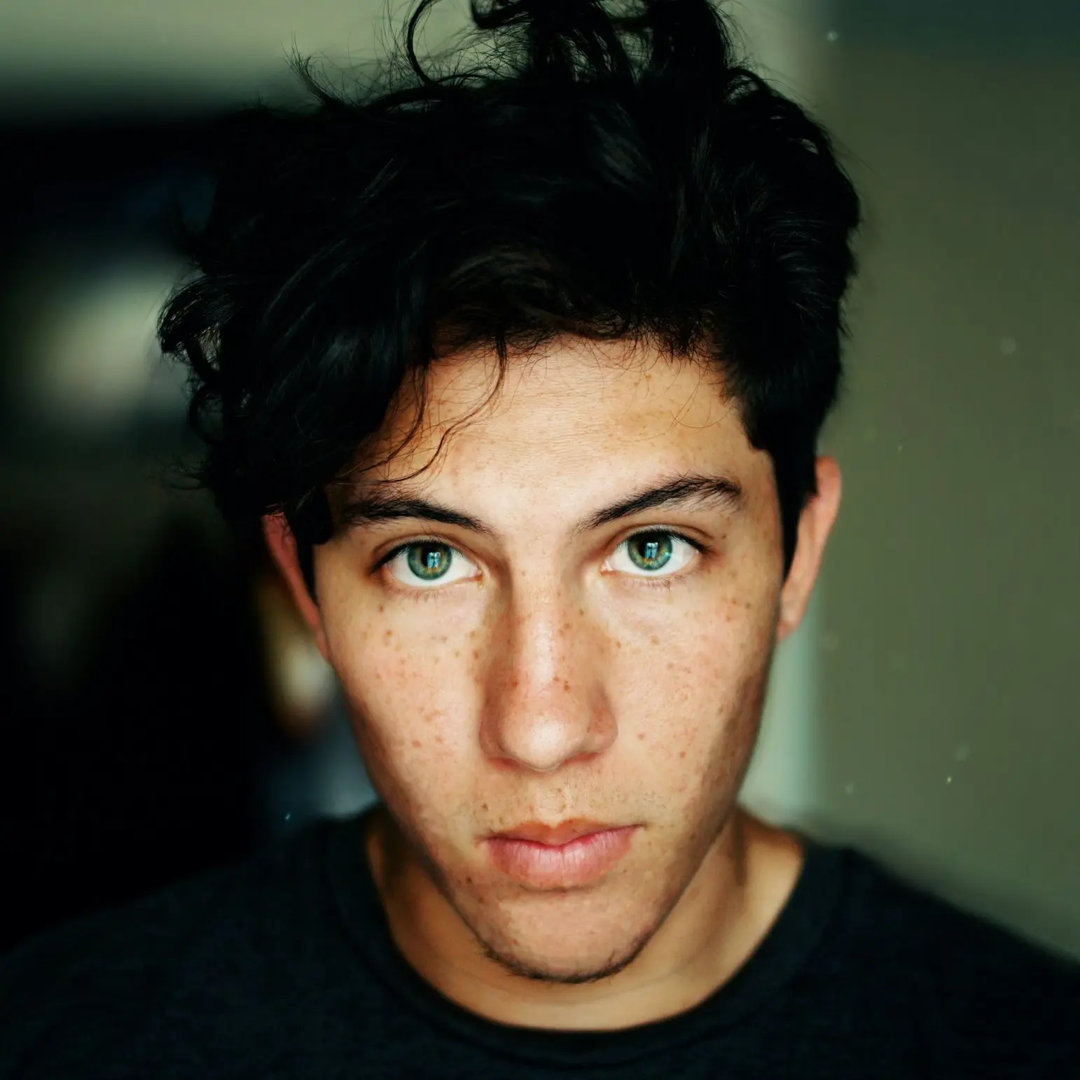 man wearing black crew-neck shirt